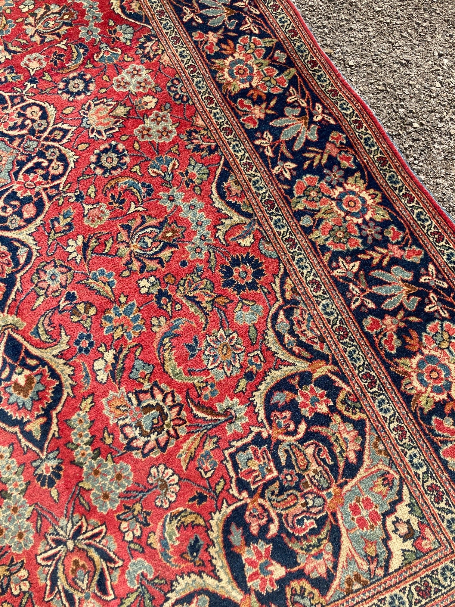 A Kashan red ground rug, with all-over stylised floral motifs